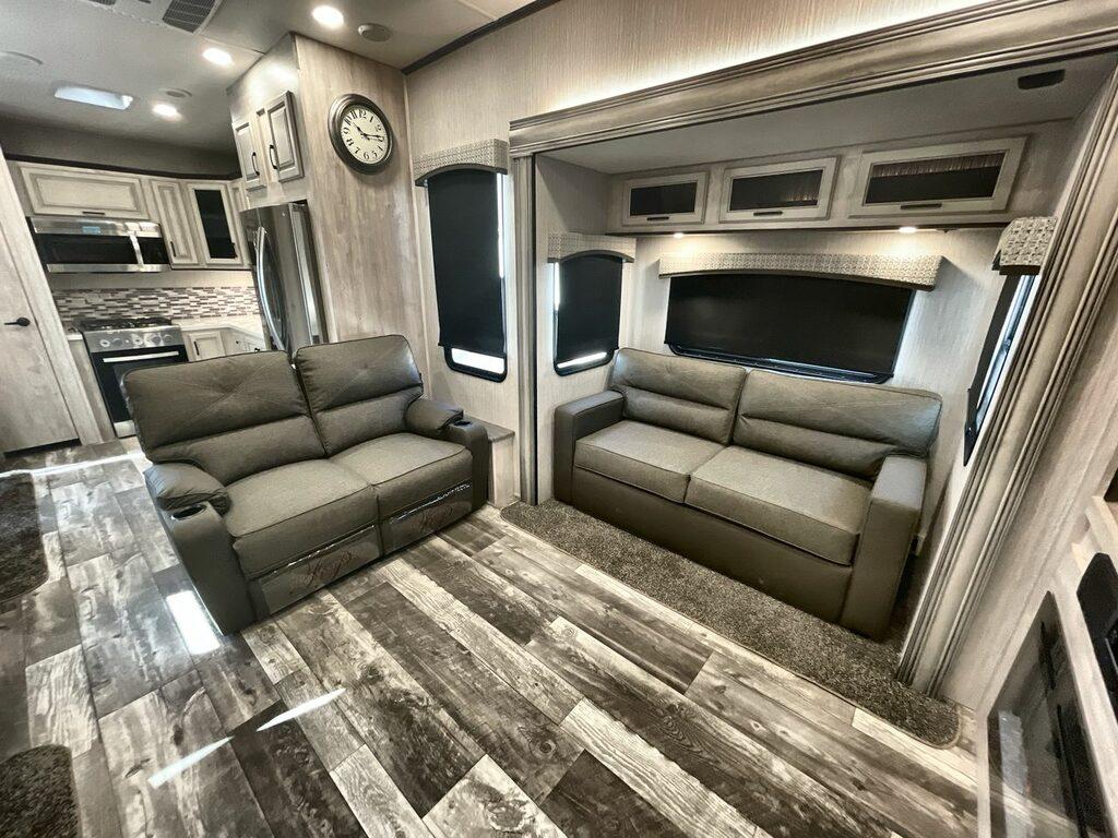 interior of a Sandpiper Luxury 39BARK, showing two couches and rear kitchen