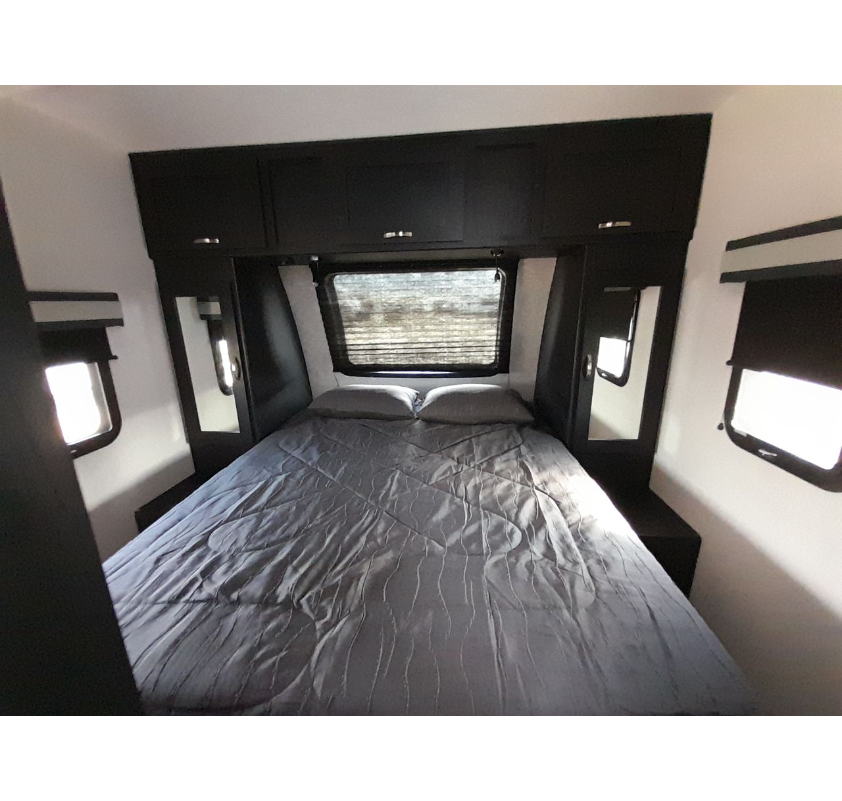 Bedroom in the Coachmen Freedom Express Liberty Edition travel trailer.